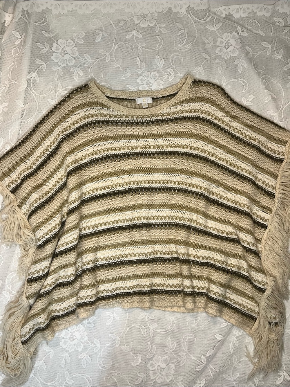 Crochet poncho with fringe sleeves
